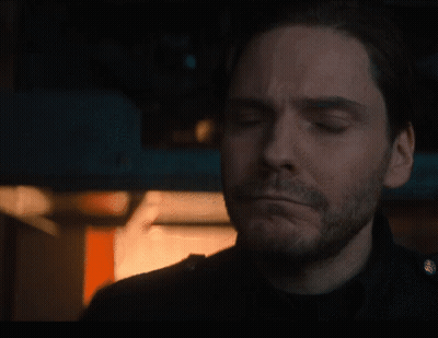 Bearded Man Looking At Camera In Dark Room GIF