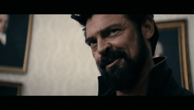 Bearded Man Looking At Camera In Front Of Painting GIF