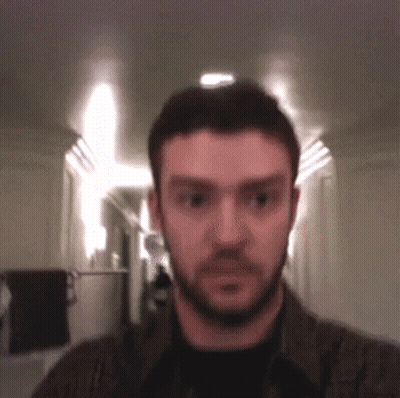 Bearded Man Looking At Camera In Hallway GIF