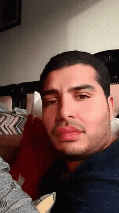 Bearded Man Looking At Camera On Bed GIF