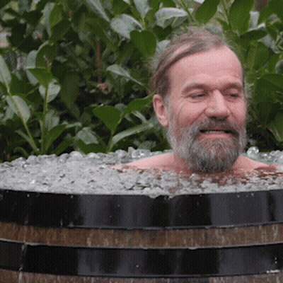 Bearded Man Lying In Barrel Of Ice GIF