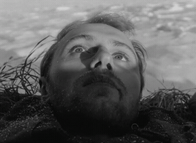 Bearded Man Lying On Ground Looking Up GIF
