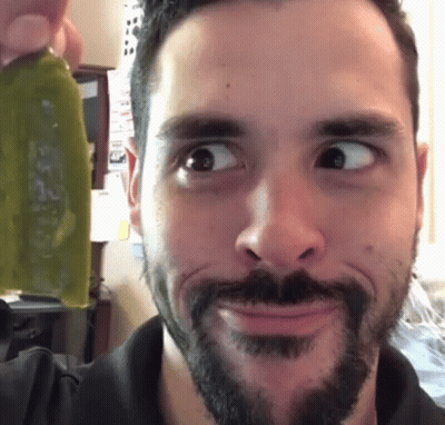 Bearded Man Making Funny Face Holding Green Object