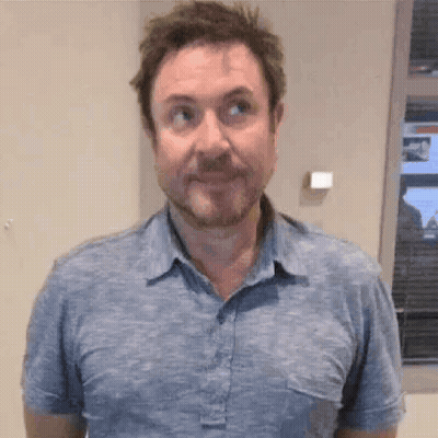 Bearded Man Making Funny Face In Blue Shirt GIF