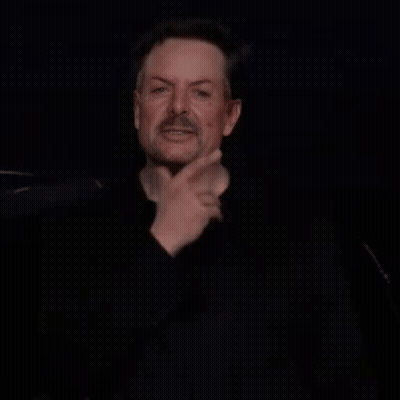 Bearded Man Making Funny Face In Dark Room GIF