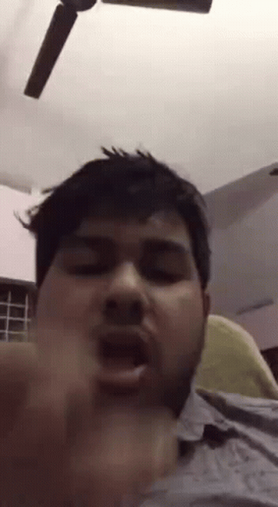 Bearded Man Making Funny Face In Front Of Ceiling Fan GIF