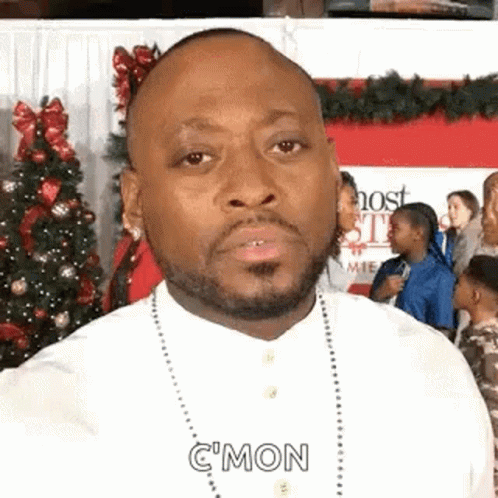 Bearded Man Making Funny Face In Front Of Christmas Tree GIF