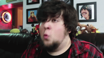 Bearded Man Making Funny Face In Front Of Coca Cola Sign GIF