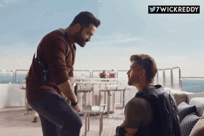 Bearded Man Next To Red Bus Saying Tome Pogg GIF