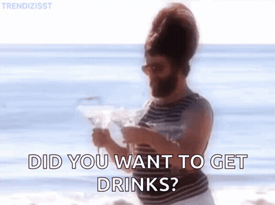 Bearded Man On Beach Holding Martini Asking If He Wants Drinks GIF