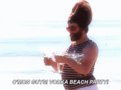 Bearded Man On Beach Holding Vodka And Martini GIF