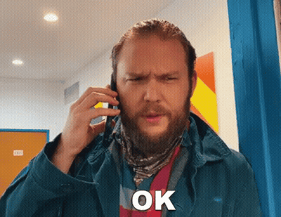 Bearded Man On Cell Phone Saying Ok GIF