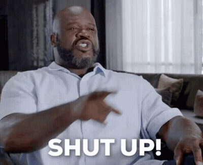 Bearded Man On Couch Pointing Saying Shut Up GIF