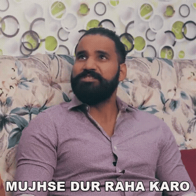 Bearded Man On Couch Saying Mujhse Dur Raha Karo GIF