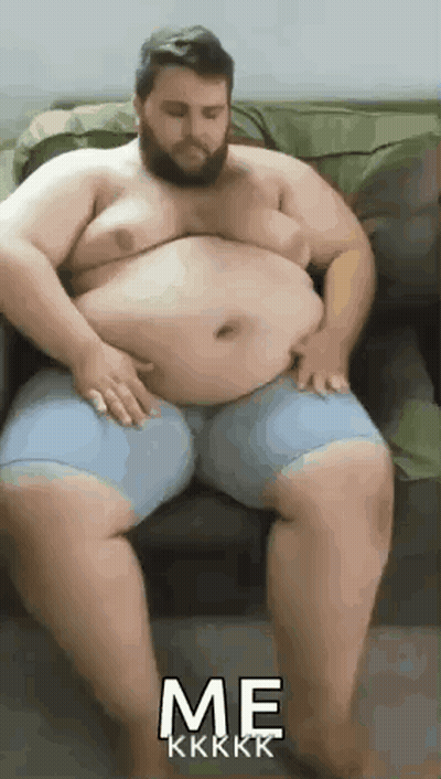 Bearded Man On Couch With Hands On Belly GIF