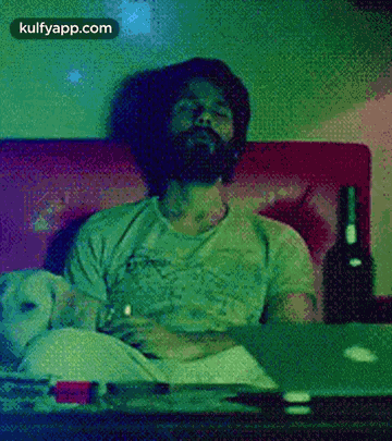 Bearded Man On Couch With Wine And Laptop GIF