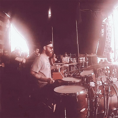 Bearded Man Playing Drums For Crowd GIF