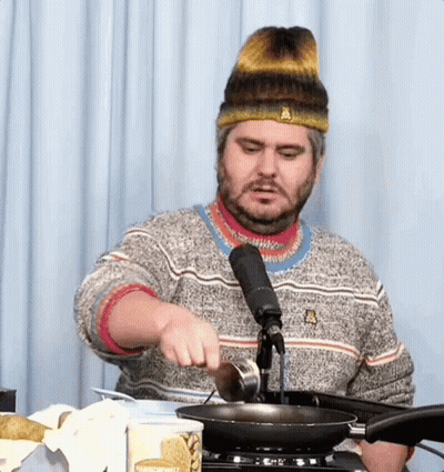 Bearded Man Pouring Oil Into Frying Pan GIF
