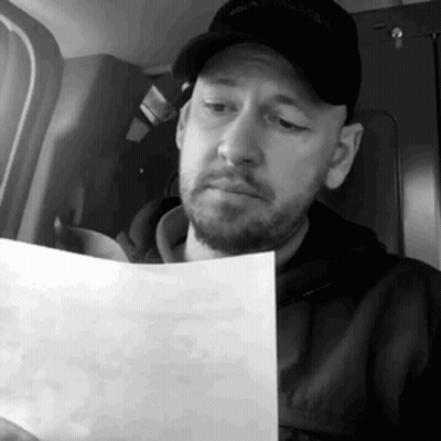 Bearded Man Reading Paper GIF