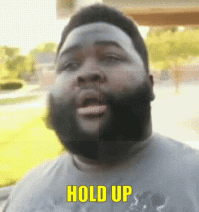 Bearded Man Saying Hold Up In Yellow Letters GIF