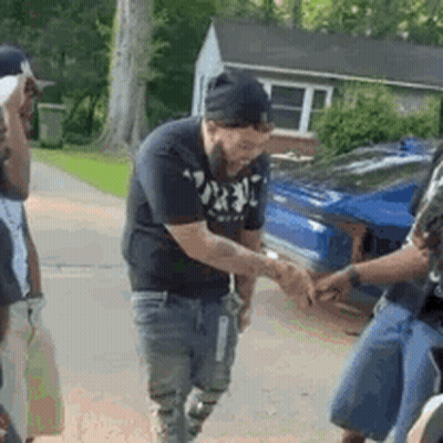 Bearded Man Shaking Hands With Another Man In Front Of Car GIF