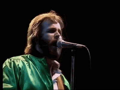 Bearded Man Singing Into Microphone In Green Shirt GIF