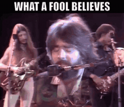 Bearded Man Singing Into Microphone Playing Guitar GIF