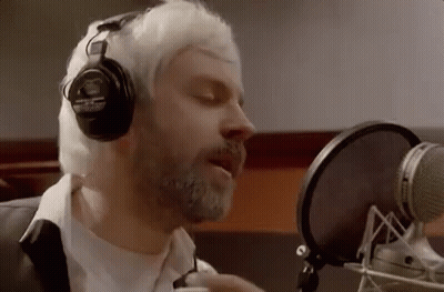 Bearded Man Singing Into Microphone With Headphones GIF