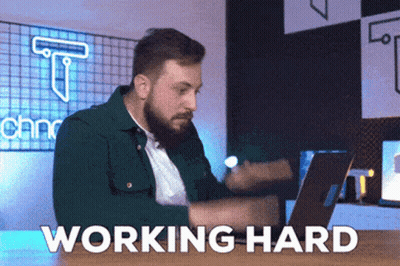 Bearded Man Sitting At Desk With Laptop Working Hard GIF