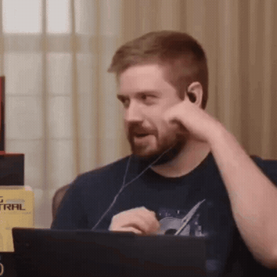 Bearded Man Sitting At Laptop With Headphones GIF