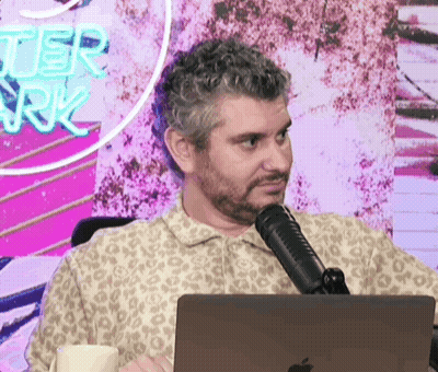 Bearded Man Sitting at Microphone and Laptop