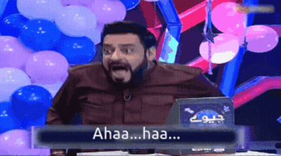 Bearded Man Sitting At Table With Balloons Saying Ahaa Haa GIF