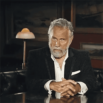 Bearded Man Sitting At Table With Folded Hands GIF