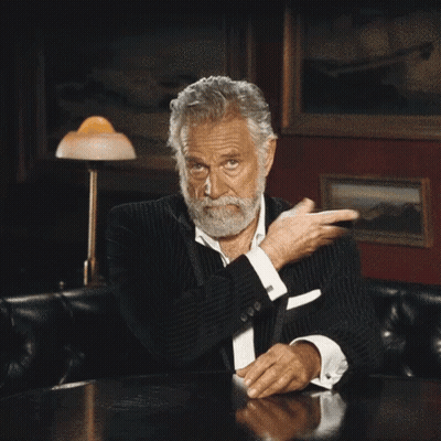 Bearded Man Sitting At Table With Folded Hands GIF