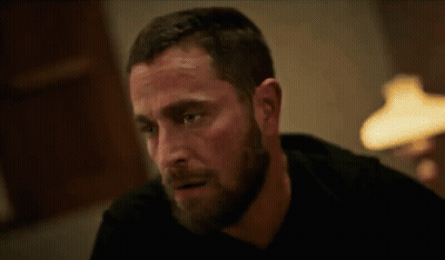 Bearded Man Sitting At Table With Lamp GIF