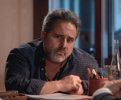 Bearded Man Sitting At Table With Water Bottle GIF