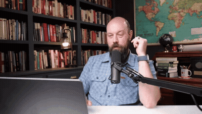 Bearded Man Sitting Before Microphone GIF