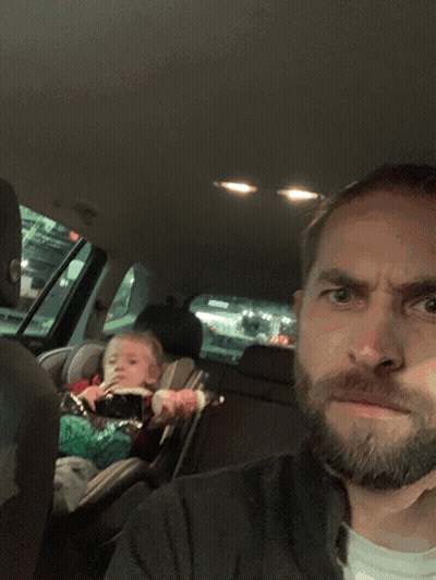 Bearded Man Sitting In Car With Baby In Car Seat GIF