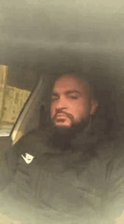 Bearded Man Sitting In Car With Eyes Closed GIF