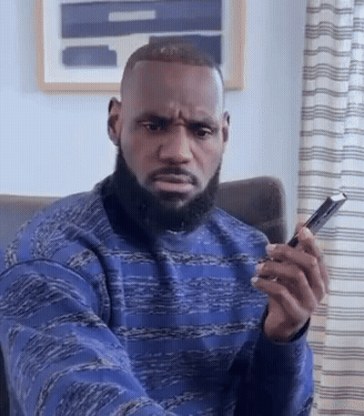 Bearded Man Sitting In Chair Holding Phone GIF
