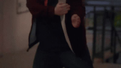 Bearded Man Sitting In Front Of Blues Sign GIF