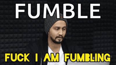 Bearded Man Sitting In Front Of Fumble Fuck Sign GIF