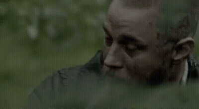 Bearded Man Sitting In Woods Near Waterfall GIF