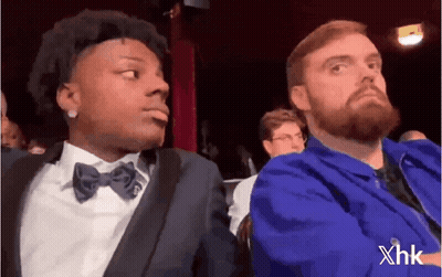 Bearded Man Sitting Next To Man In Suit And Bow Tie GIF