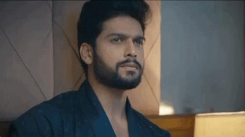 Bearded Man Sitting On Bed GIF