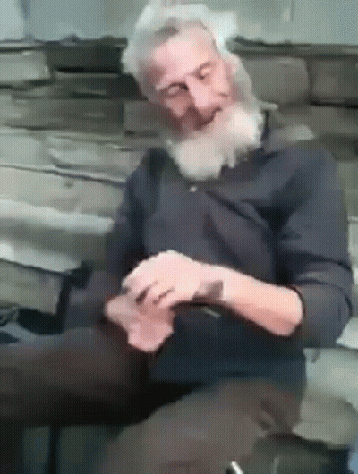 Bearded Man Sitting on Bench Playing Cards Eyes Closed