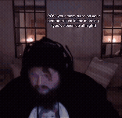 Bearded Man Sitting On Couch In Dark Room GIF