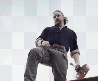 Bearded Man Sitting On Ledge Holding Skateboard GIF