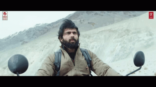 Bearded Man Sitting On Motorcycle In Desert GIF