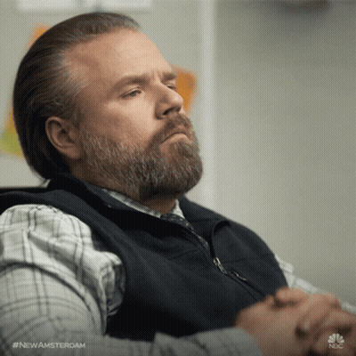 Bearded Man Sitting With Folded Hands GIF